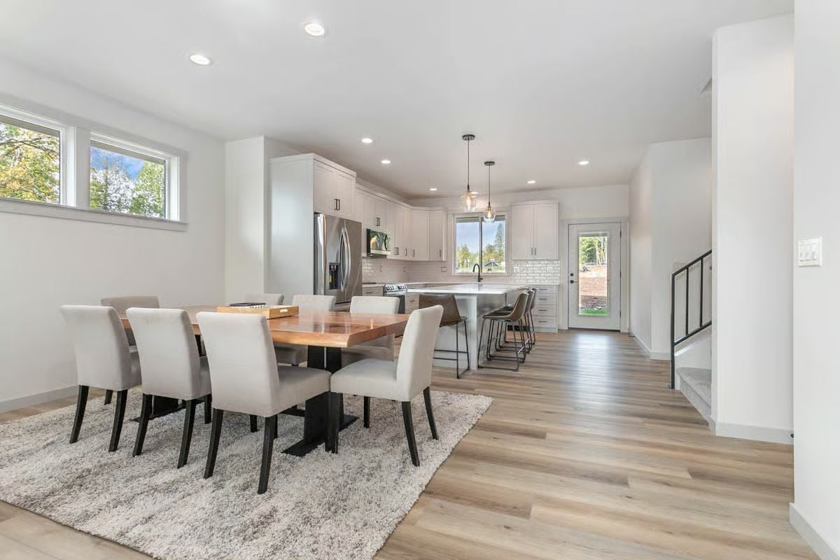 Warm Wood Table Anchors an Open-Plan Dining and Kitchen Space