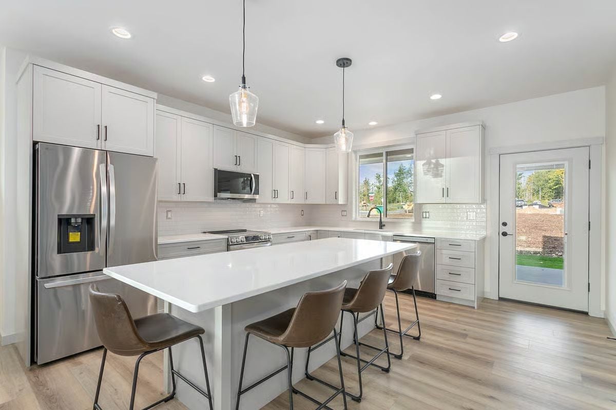 Quartz Island with Brown Leather Barstools in a White Shaker Kitchen