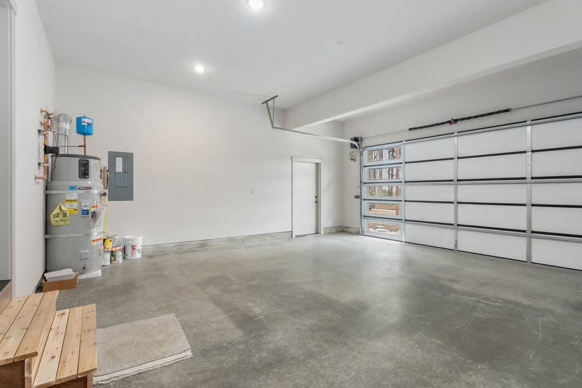Polished Concrete Floors and Glass Panel Garage Doors in a Two-Car Bay