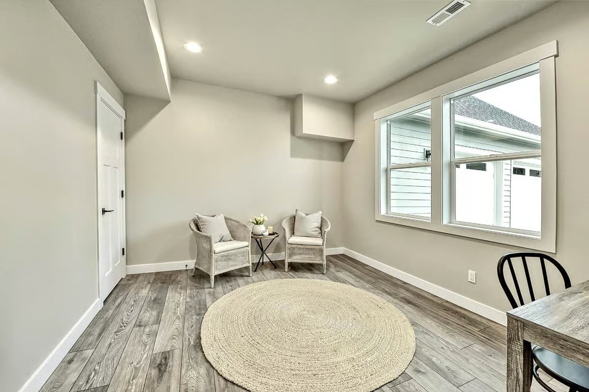 Wicker Chairs and a Jute Rug Make the Bonus Room Worth Lingering In