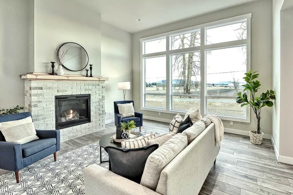 Gray Brick Fireplace and Big Windows Pull the Room in Two Directions