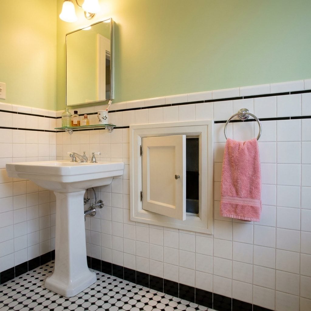 The Built-In Laundry Chute Hidden Behind a Tiny Cabinet Door in the Wall