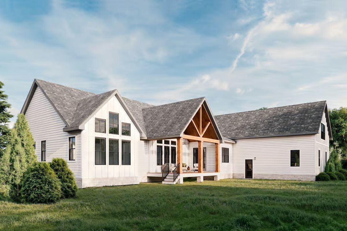 Warm Timber Framing Anchors a White Farmhouse Rear Exterior