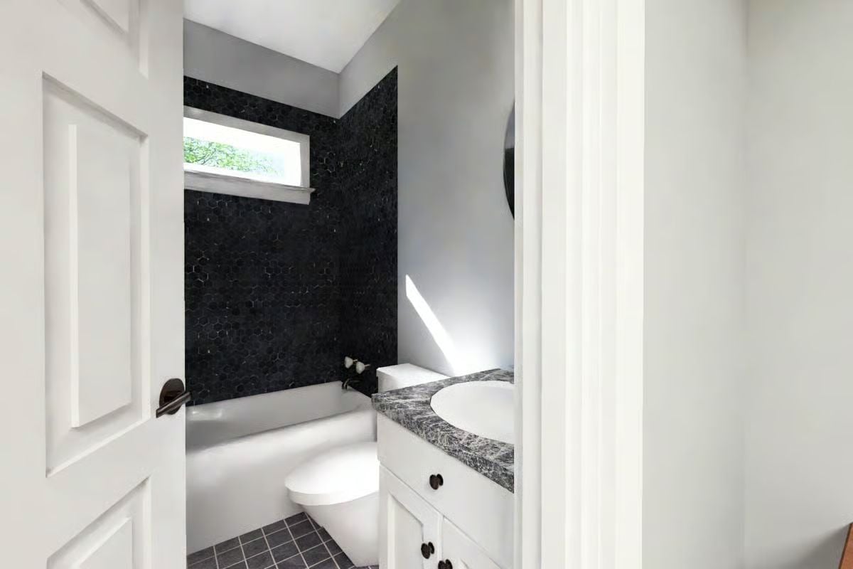 Black Hex Tile and a Soaking Tub That Pull the Most Weight in a Small Bath