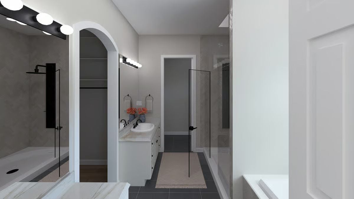 Black Fixtures, Glass Panel, and a Master Bath That Keeps Its Geometry Clean