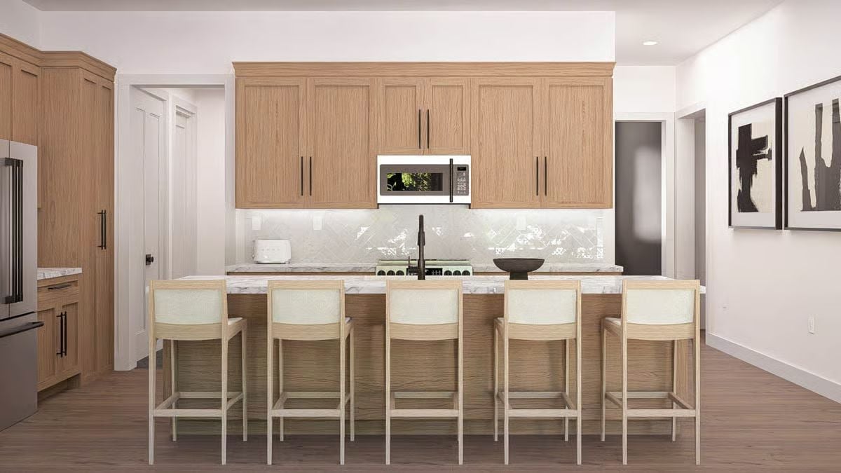 Natural Wood Cabinets and Marble Counters Pull This Kitchen Together
