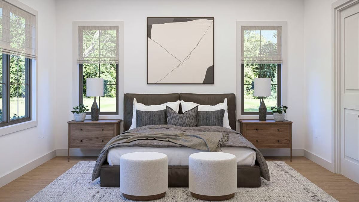 Boucle Ottomans and a Leather Bed Frame That Ground the Room