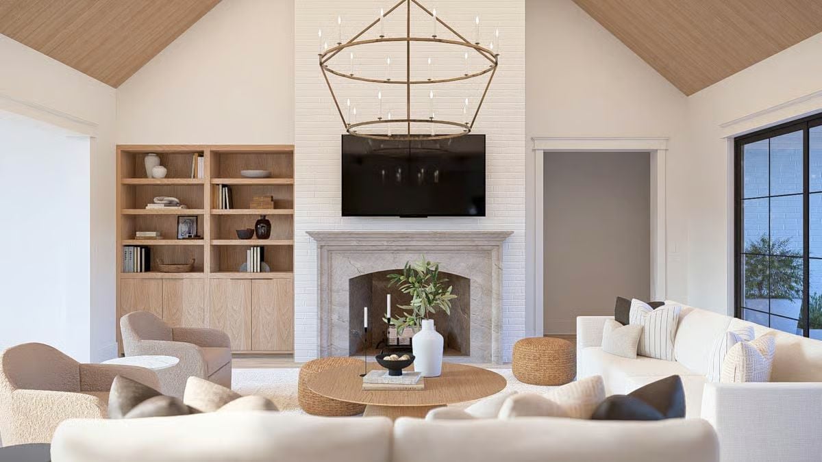Vaulted Great Room Where Marble Fireplace and Rattan Coffee Table Share the Floor