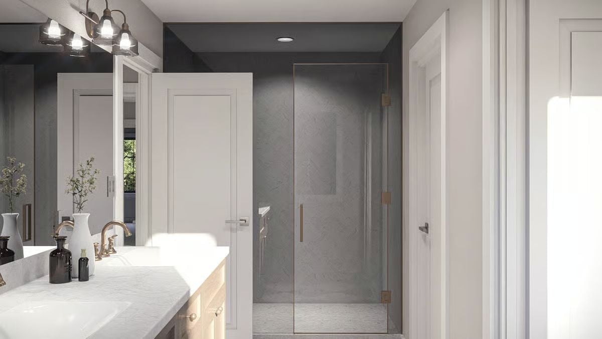 Frameless Glass and Brushed Gold Hardware Keep This Shower Feeling Open