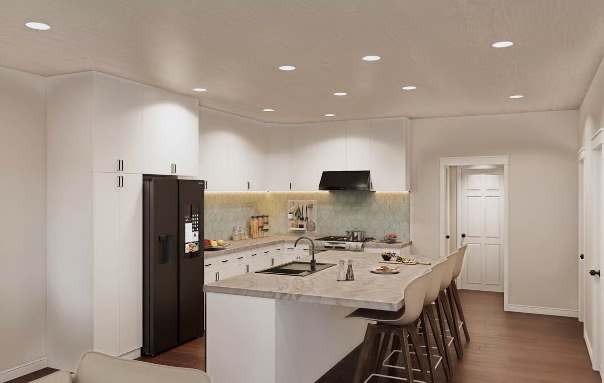 Black Fridge, White Cabinets, and a Waterfall Island That Pulls It Together