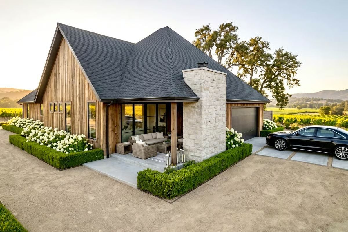 Cedar Siding, Stone Chimney, and Vineyard Views Beyond the Patio