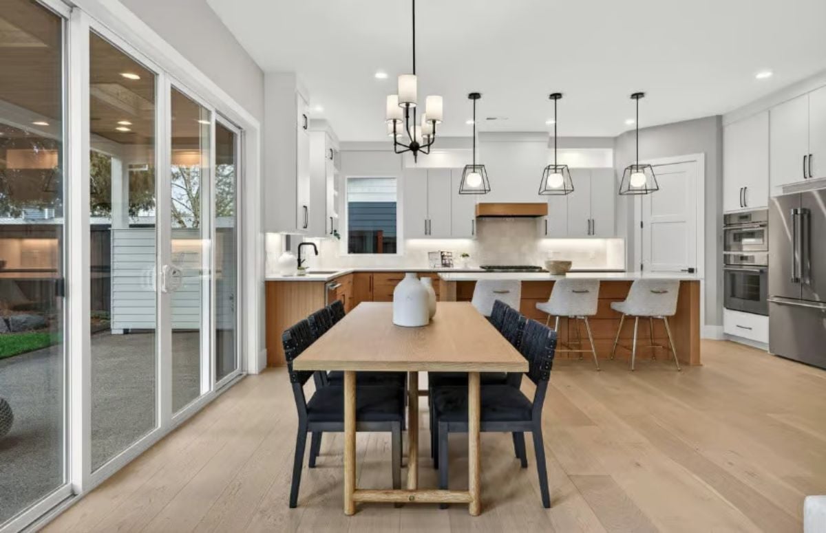Light Wood and Black Accents Anchor an Open Kitchen-Dining Space