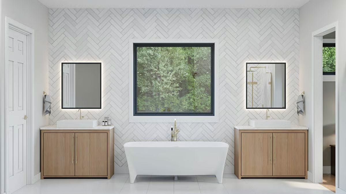 Dual Vanities, a Soaking Tub, and Herringbone Tile That Carries the Whole Wall