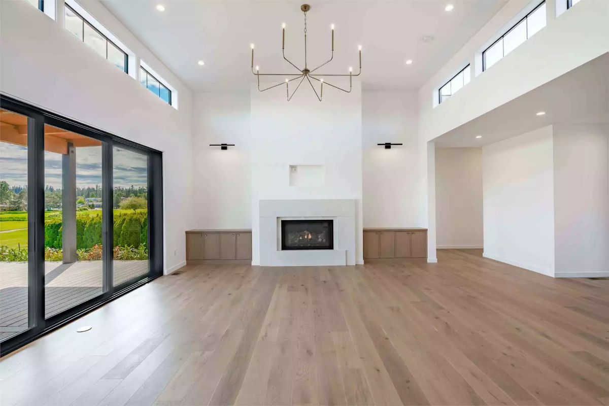 Soaring Ceilings and a Linear Fireplace Define This Unfurnished Great Room