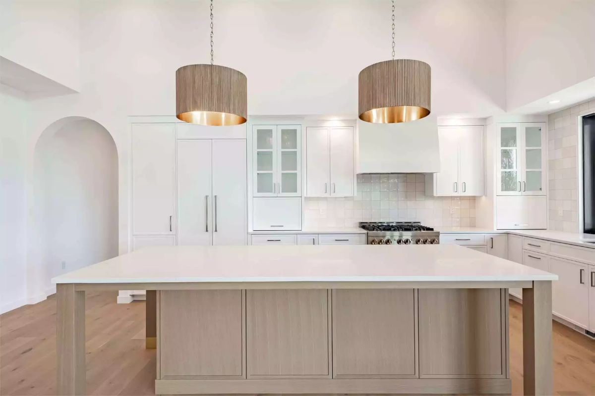 Drum Pendants with Brass Interiors Over a Two-Tone Kitchen Island