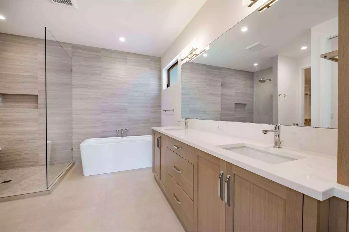Quartz Countertops and Warm Wood Cabinetry in a Double-Sink Primary Bath