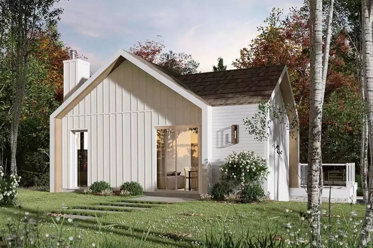 Board-and-Batten White Exterior Tucked Into an Autumn Treeline
