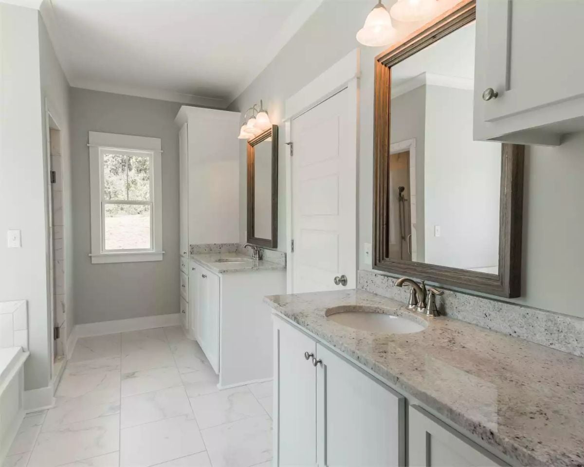 Dual Vanities and Wood-Framed Mirrors Keep This Master Bath Grounded