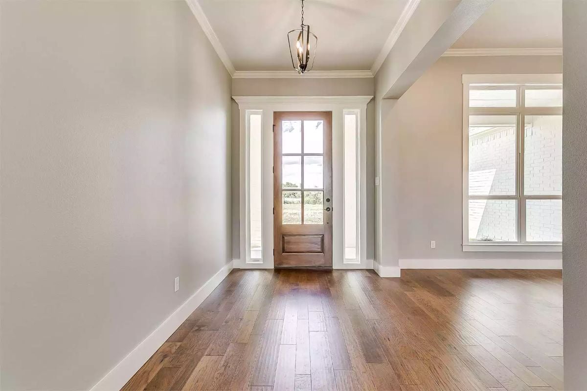Hardwood Floors and a Glass-Panel Door Invite Light Into the Entry