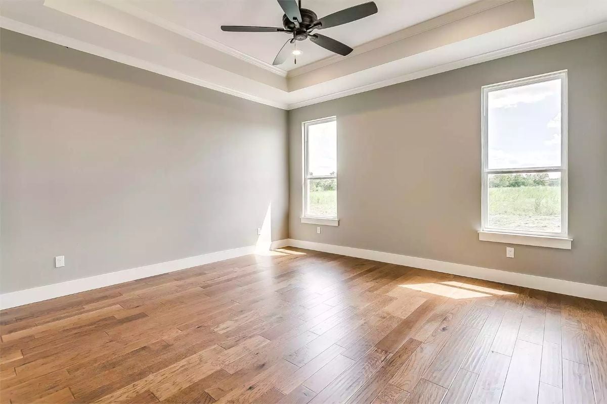 Hardwood Floors Catch the Sun While a Tray Ceiling Keeps Things Grounded