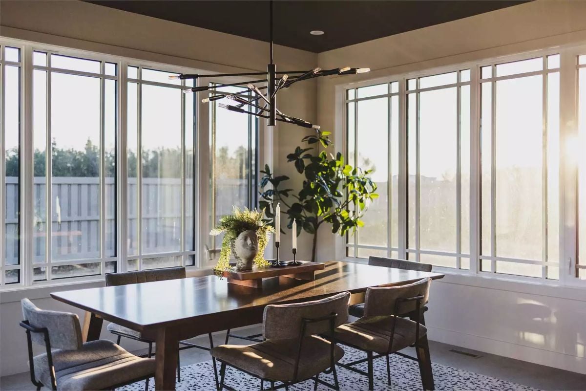 Sunlit Dining Room Where Warm Wood and Black Metal Find Common Ground