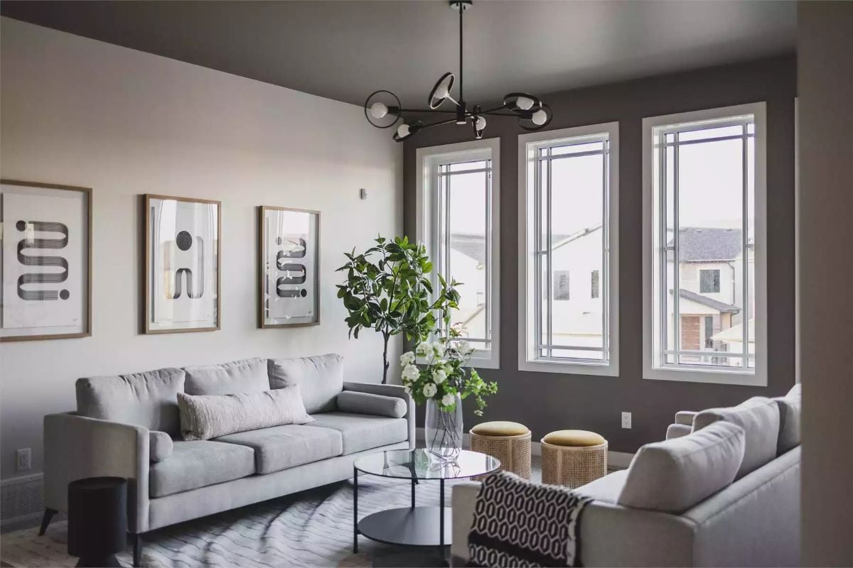 Gray Sofas, a Round Glass Table, and Ottomans That Pull Double Duty