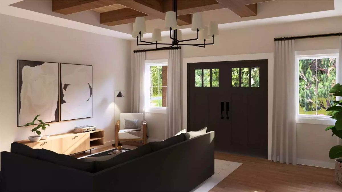 Exposed Ceiling Beams and a Dark Front Door Anchor This Warm Living Space