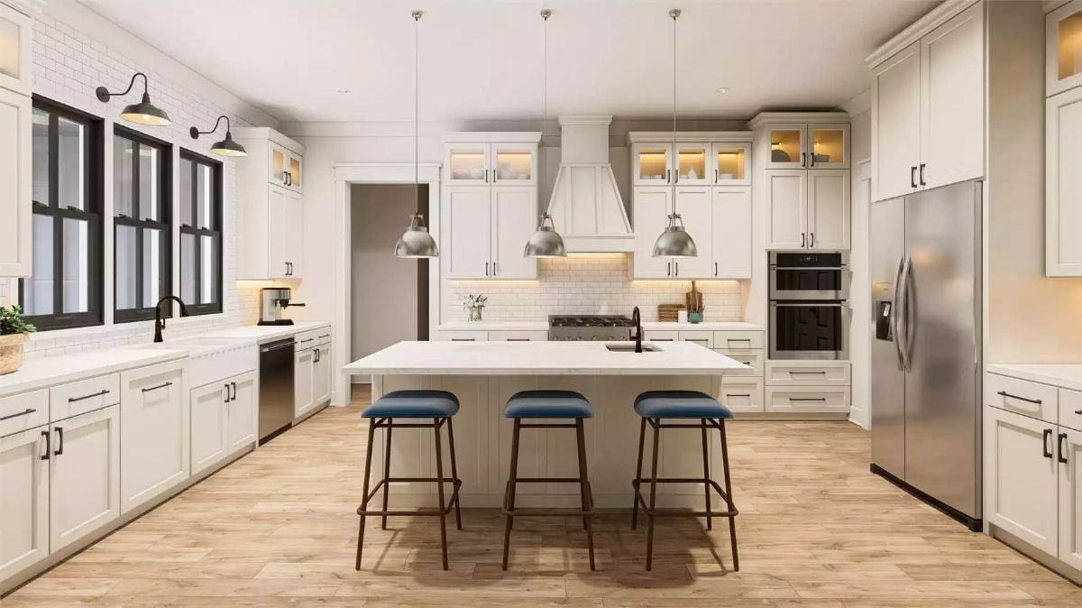 Polished Pendant Lights and Blue Stools Give This Kitchen Its Edge