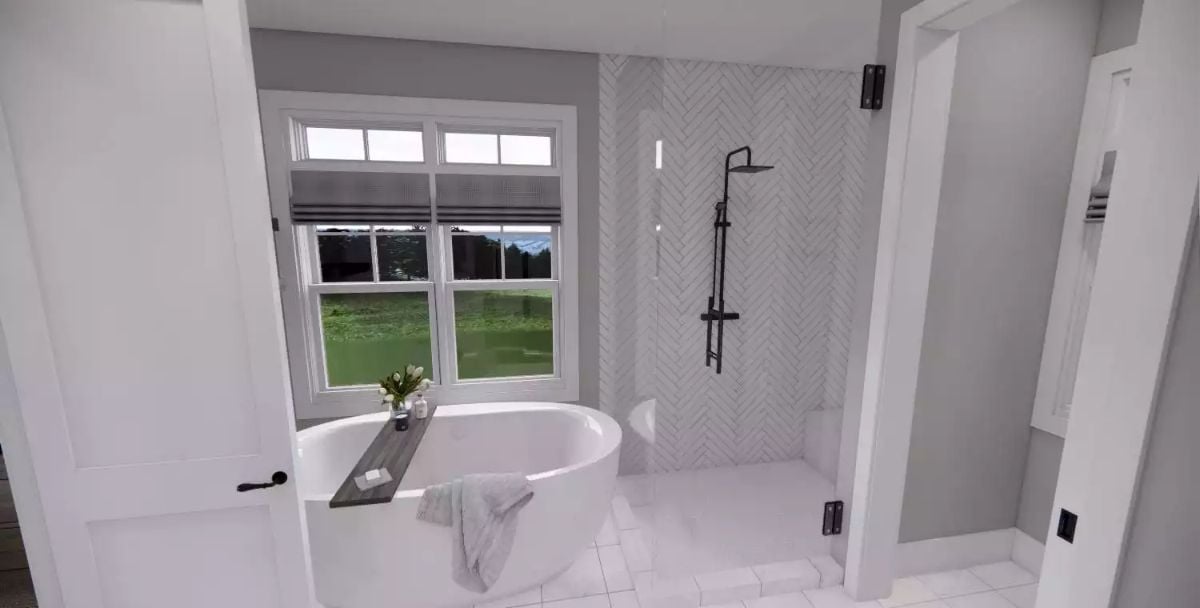 Freestanding Tub and Herringbone Shower Tile Do the Heavy Lifting Here