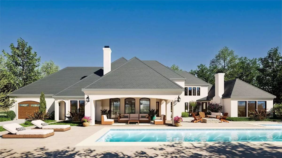 Arched Covered Patio Anchors a Resort-Style Backyard Pool Setup
