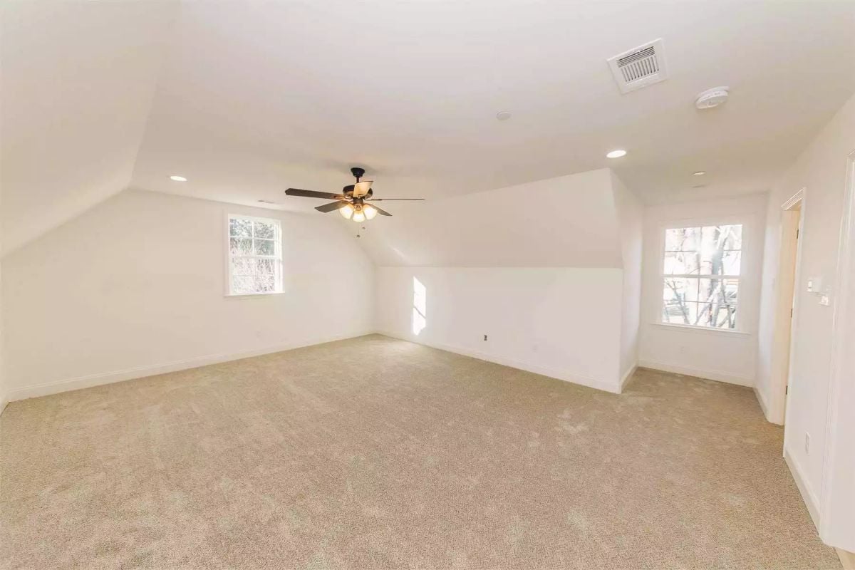 Vaulted Bonus Room With Carpet and Ceiling Fan Has Space to Spare
