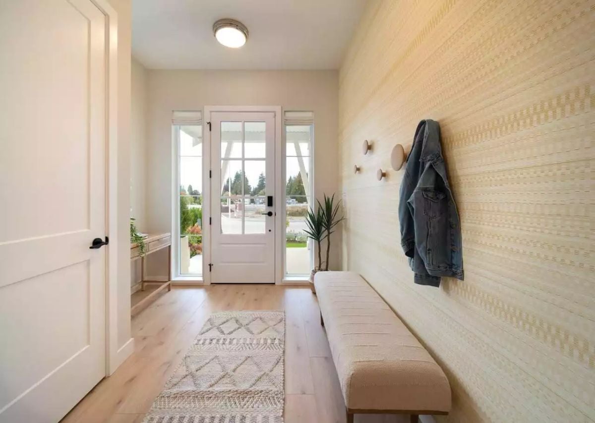 Rounded Wood Knobs and Textured Wallcovering Make This Entry Feel Considered