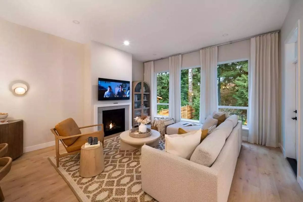 Warm Neutrals and a Live Fireplace Make This Living Room Work Hard