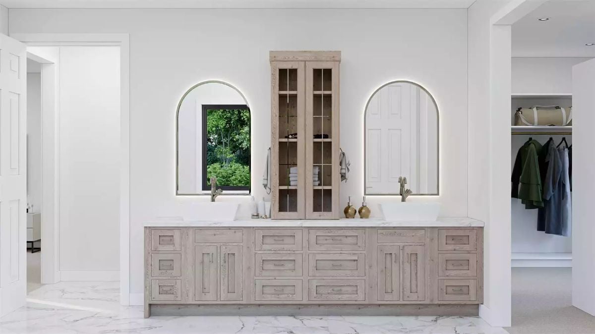 Arched Mirrors and a Tall Linen Cabinet Reshape a Double Vanity Wall