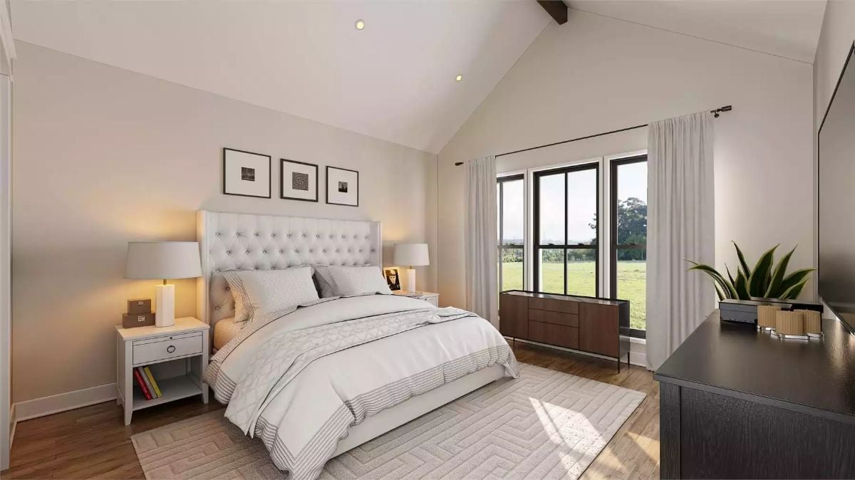 Vaulted Ceiling, Tufted Headboard, and a View of Open Fields