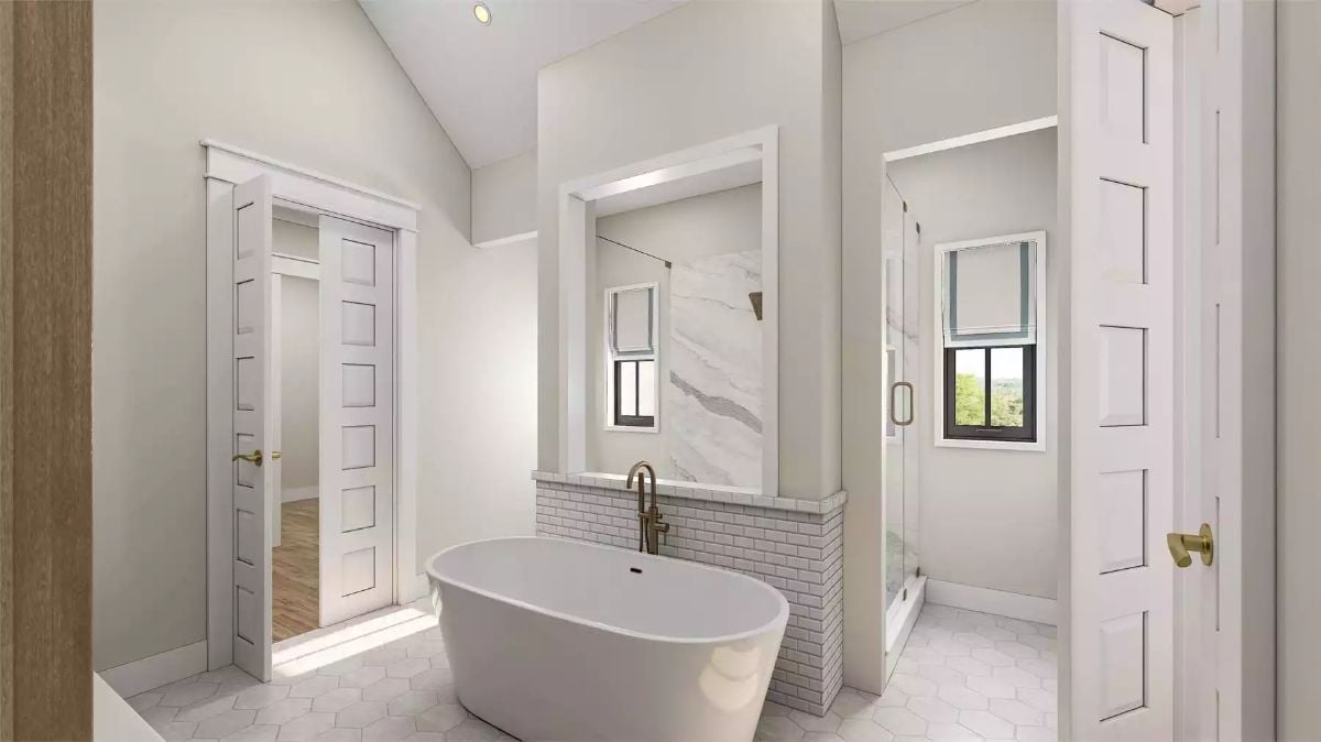 Freestanding Soaking Tub Set Against Subway Tile and Veined Marble