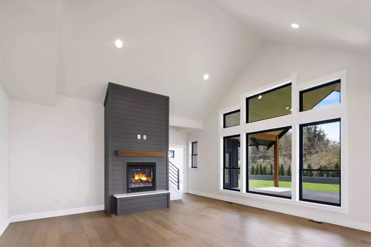 Shiplap Fireplace Tower Anchors an Otherwise Bare Living Room