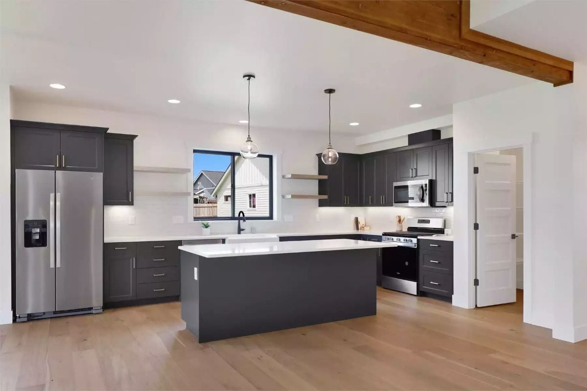 Globe Pendants and Dark Cabinetry Pull the Eye Straight to the Island