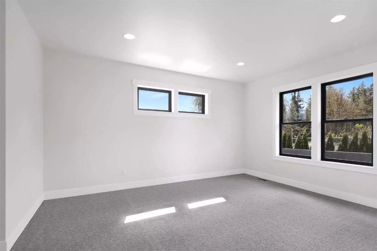 Recessed Lights and Gray Carpet Keep an Empty Bedroom Feeling Grounded