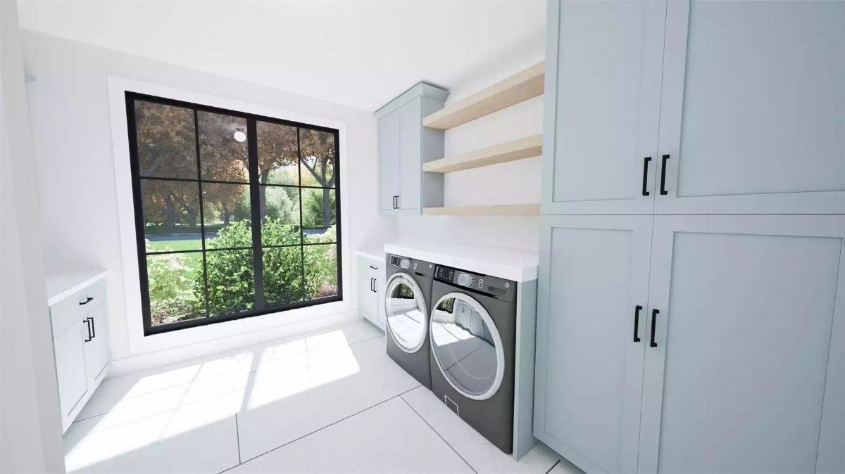 Sage Cabinets and a Black-Frame Window That Pulls the Yard Into the Wash Cycle