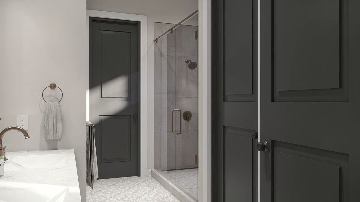Charcoal Doors and Bronze Hardware Bring Sharp Contrast to a Soft Bathroom