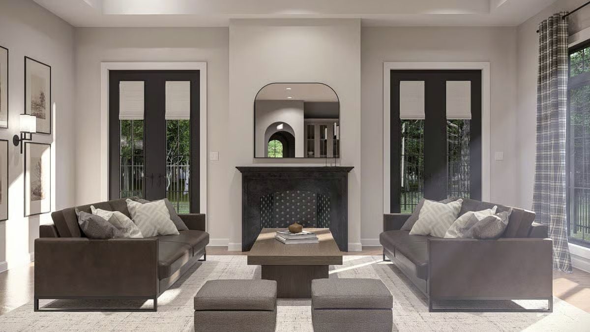 Paired Sofas and a Dark Fireplace Surround Give This Living Room Real Presence