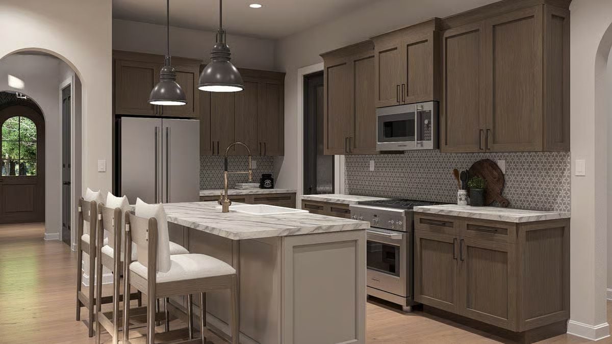 Warm Wood Cabinetry and Marble Island Make This Kitchen Worth Gathering In