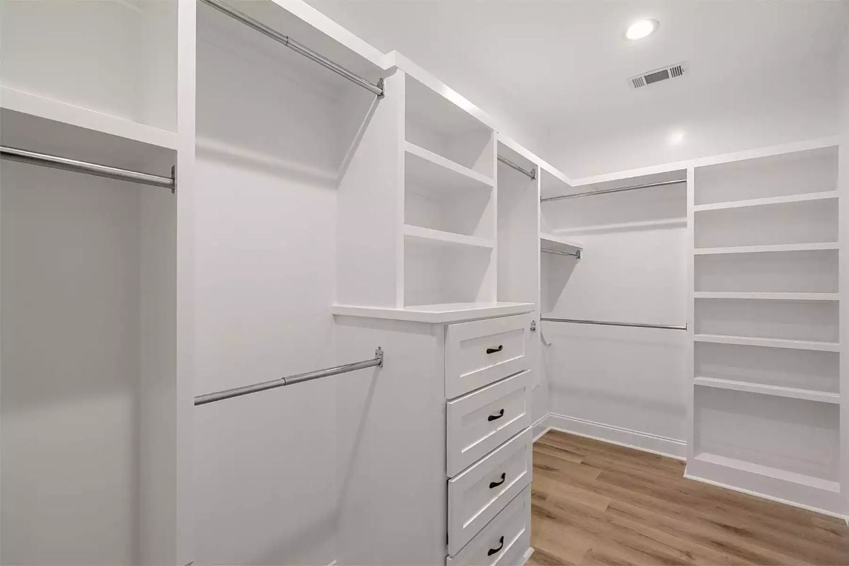 White Shelving, Hanging Rods, and a Drawer Tower Built Into the Center