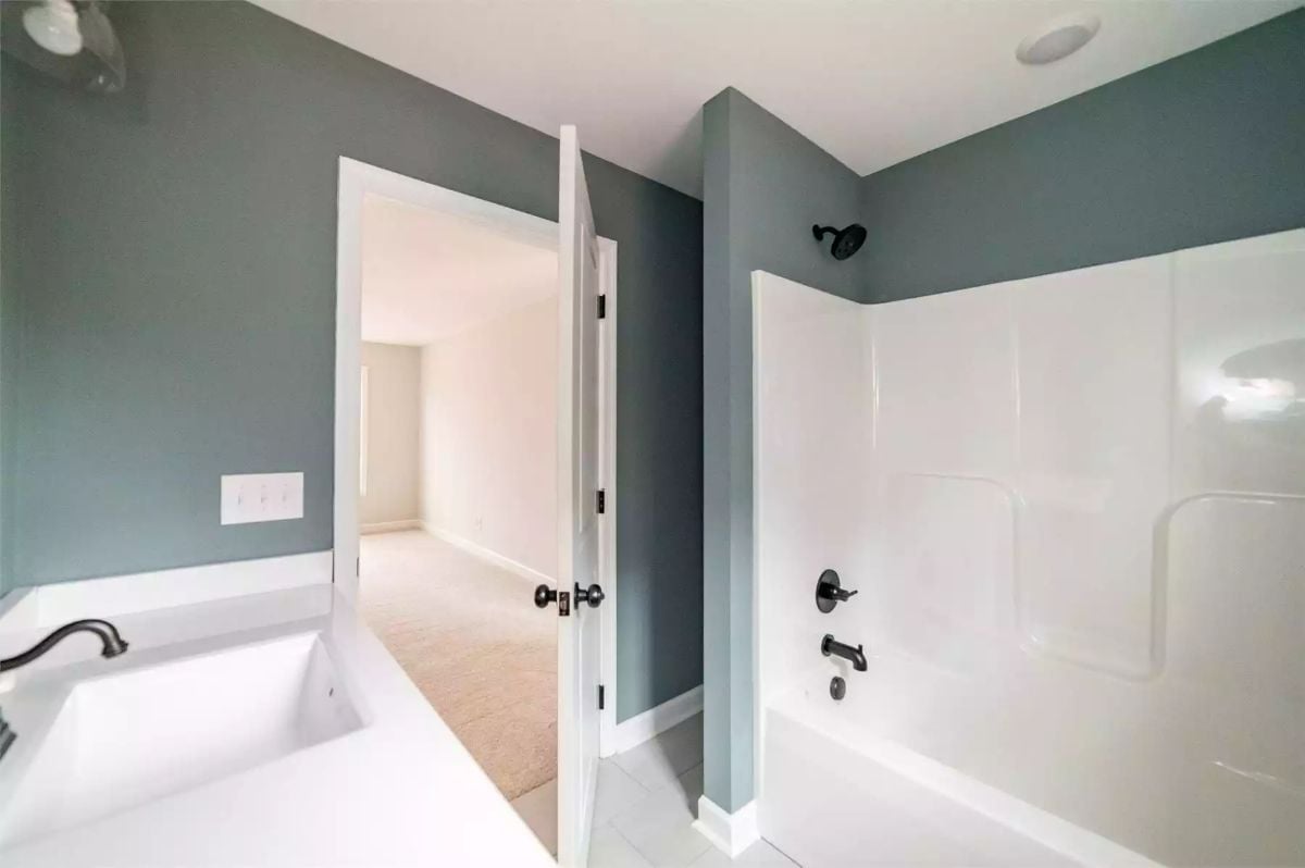Bronze Fixtures and Two Bathing Options That Settle the Soaking-vs-Showering Debate