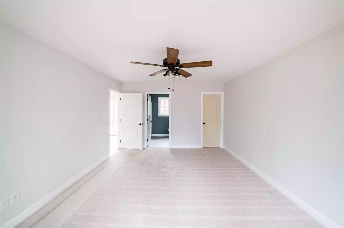 Carpet, a Ceiling Fan, and Two Doors That Tell You Exactly Where You Are