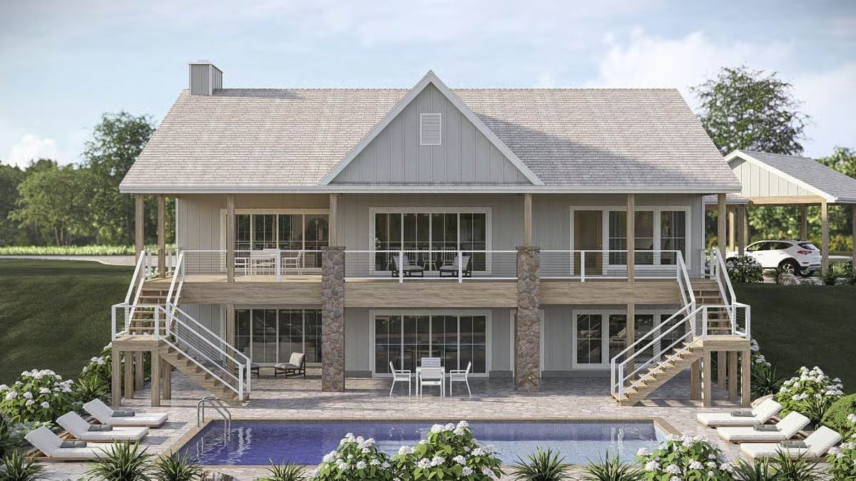 Stone Columns and Dual Staircases Frame a Back Elevation Built for Pool Days
