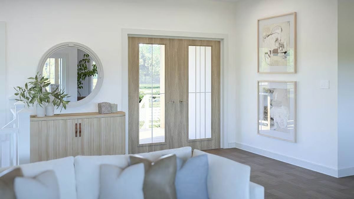 Warm Oak Doors and a Round Mirror Set the Tone Before You're Even Inside