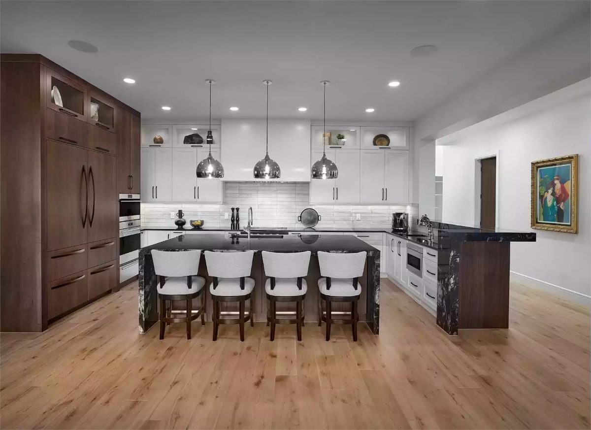 Chrome Pendants and Black Granite Pull Two Design Directions Into One Kitchen