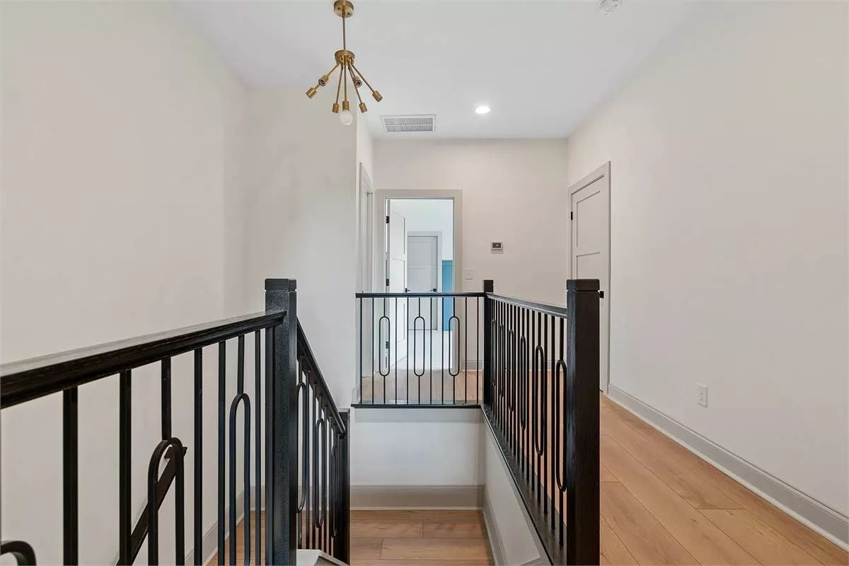 Black Iron Balusters and a Sputnik Pendant Keep This Landing From Feeling Like Dead Space